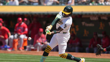 Jul 21, 2024; Oakland, California, USA; Oakland Athletics right fielder Lawrence Butler (4) hits a single against the Los Angeles Angels during the seventh inning at Oakland-Alameda County Coliseum. Mandatory Credit: Darren Yamashita-USA TODAY Sports