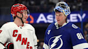 Jan 7, 2025; Tampa, Florida, USA; Carolina Hurricanes right wing Andrei Svechnikov (37) and Tampa Bay Lightning goaltender Andrei Vasilevskiy (88) talk during the second period at Amalie Arena. Mandatory Credit: Kim Klement Neitzel-Imagn Images