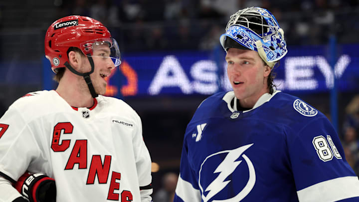 Jan 7, 2025; Tampa, Florida, USA; Carolina Hurricanes right wing Andrei Svechnikov (37) and Tampa Bay Lightning goaltender Andrei Vasilevskiy (88) talk during the second period at Amalie Arena. Mandatory Credit: Kim Klement Neitzel-Imagn Images