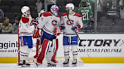 Jan 16, 2025; Dallas, Texas, USA; Montreal Canadiens center Kirby Dach (77) and goaltender Jakub Dobes (75) and defenseman Arber Xhekaj (72) celebrate on the ice after defeating the Dallas Stars at the American Airlines Center. Mandatory Credit: Jerome Miron-Imagn Images