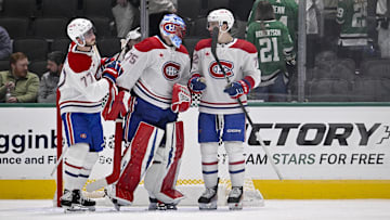 Jan 16, 2025; Dallas, Texas, USA; Montreal Canadiens center Kirby Dach (77) and goaltender Jakub Dobes (75) and defenseman Arber Xhekaj (72) celebrate on the ice after defeating the Dallas Stars at the American Airlines Center. Mandatory Credit: Jerome Miron-Imagn Images
