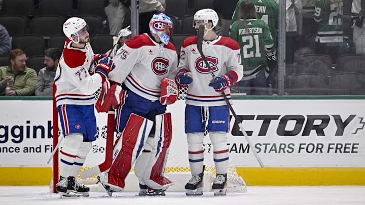 Jan 16, 2025; Dallas, Texas, USA; Montreal Canadiens center Kirby Dach (77) and goaltender Jakub Dobes (75) and defenseman Arber Xhekaj (72) celebrate on the ice after defeating the Dallas Stars at the American Airlines Center. Mandatory Credit: Jerome Miron-Imagn Images