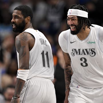 Dallas Mavericks forward Anthony Davis and guard Kyrie Irving celebrate after a dunk.