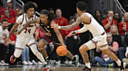 Feb 22, 2025; Louisville, Kentucky, USA;  Florida State Seminoles guard Daquan Davis (5) dribbles against Louisville Cardinals guard Chucky Hepburn (24) and guard Terrence Edwards Jr. (5) during the first half at KFC Yum! Center. Mandatory Credit: Jamie Rhodes-Imagn Images