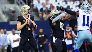 Sep 15, 2024; Arlington, Texas, USA; New Orleans Saints quarterback Derek Carr (4) throws as Dallas Cowboys linebacker Micah Parsons (11) tries to pressure during the first quarter at AT&T Stadium. Mandatory Credit: Kevin Jairaj-Imagn Images
