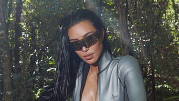Kim Kardashian was photographed by Greg Swales in the Dominican Republic. Swimsuit by Abysse. Gloves by Fox.