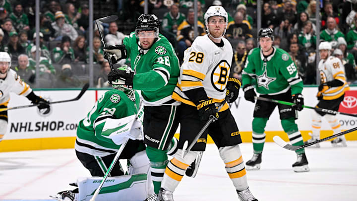 Jan 20, 2026; Dallas, Texas, USA;  Dallas Stars defenseman Ilya Lyubushkin (46) and Boston Bruins center Elias Lindholm (28) look for the puck during the game at the American Airlines Center. Mandatory Credit: Jerome Miron-Imagn Images