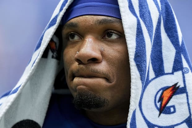 Indianapolis Colts quarterback Anthony Richardson (5) leaves the field with a blue towel on his head.