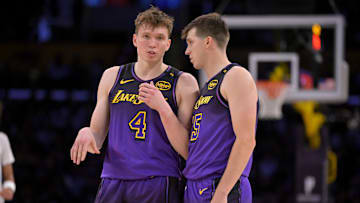 Nov 21, 2024; Los Angeles, California, USA; Los Angeles Lakers guard Dalton Knecht (4) and guard Austin Reaves (15) talk on the court in the first half against the Orlando Magic at Crypto.com Arena. Mandatory Credit: Jayne Kamin-Oncea-Imagn Images
