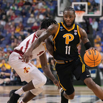 Mar 17, 2023; Greensboro, NC, USA; Pittsburgh Panthers guard Jamarius Burton (11) dribbles the ball past Iowa State Cyclones guard Demarion Watson (4) during the first half at Greensboro Coliseum. Mandatory Credit: Bob Donnan-USA TODAY Sports