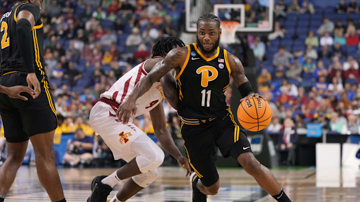 Mar 17, 2023; Greensboro, NC, USA; Pittsburgh Panthers guard Jamarius Burton (11) dribbles the ball past Iowa State Cyclones guard Demarion Watson (4) during the first half at Greensboro Coliseum. Mandatory Credit: Bob Donnan-USA TODAY Sports