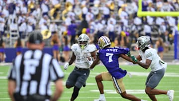 Sep 7, 2024; Seattle, Washington, USA; Eastern Michigan Eagles running back Delbert Mimms III (34) carries the ball while Washington Huskies cornerback Ephesians Prysock (7) is held during the second half at Alaska Airlines Field at Husky Stadium. Mandatory Credit: Steven Bisig-Imagn Images