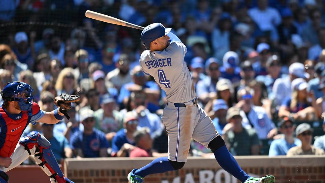 Jun 19, 2026; Chicago, Illinois, USA; Toronto Blue Jays designated hitter George Springer (4) hits a home run against the Chicago Cubs during the sixth inning at Wrigley Field. Mandatory Credit: Patrick Gorski-Imagn Images