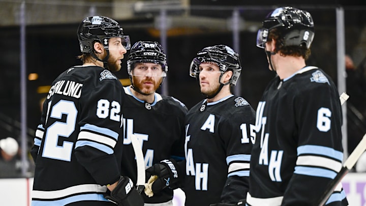 Jan 18, 2025; Salt Lake City, Utah, USA; Utah Hockey Club center Kevin Stenlund (82), defenseman Ian Cole (28), center Alexander Kerfoot (15), and defenseman John Marino (6) discuss a play before a face-off against the St. Louis Blues during third period at the Delta Center. Mandatory Credit: Christopher Creveling-Imagn Images