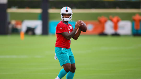 Jul 24, 2024; Miami Gardens, FL, USA; Miami Dolphins quarterback Tua Tagovailoa (1) holds the football during training camp at Baptist Health Training Complex.