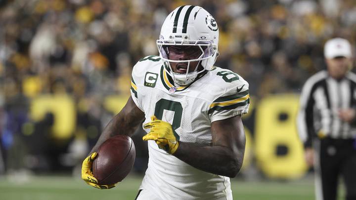 Green Bay Packers running back Josh Jacobs (8) runs the ball