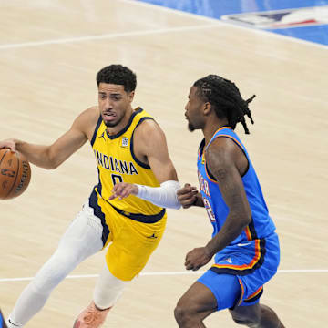 Jun 8, 2025; Oklahoma City, Oklahoma, USA; Indiana Pacers guard Tyrese Haliburton (0) dribbles the ball against Oklahoma City Thunder guard Cason Wallace (22) during the first quarter during game two of the 2025 NBA Finals at Paycom Center. Mandatory Credit: Kyle Terada-Imagn Images