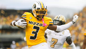 Sep 21, 2024; Columbia, Missouri, USA; Missouri Tigers wide receiver Luther Burden III (3) scores a touchdown against Vanderbilt Commodores safety Marlen Sewell (7) during the first half at Faurot Field at Memorial Stadium. Mandatory Credit: Jay Biggerstaff-Imagn Images
