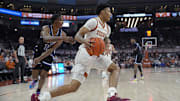 Jan 1, 2024; Austin, Texas, USA; Texas Longhorns guard Chris Johnson (0) drives to the basket past Texas-Arlington Mavericks guard Kade Douglas (13) during the first half at Moody Center. Mandatory Credit: Scott Wachter-Imagn Images