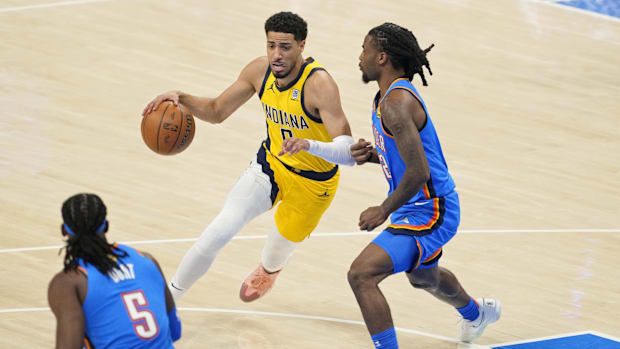 Indiana Pacers guard Tyrese Haliburton (0) dribbles the ball against Oklahoma City Thunder guard Cason Wallace.