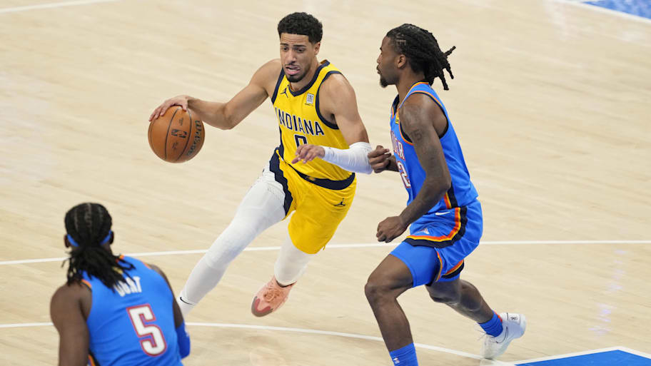 Indiana Pacers guard Tyrese Haliburton (0) dribbles the ball against Oklahoma City Thunder guard Cason Wallace.