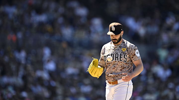 Aug 25, 2024; San Diego, California, USA; San Diego Padres relief pitcher Tanner Scott (66) tosses a ball during the eighth inning against the New York Mets at Petco Park. Mandatory Credit: Orlando Ramirez-Imagn Images