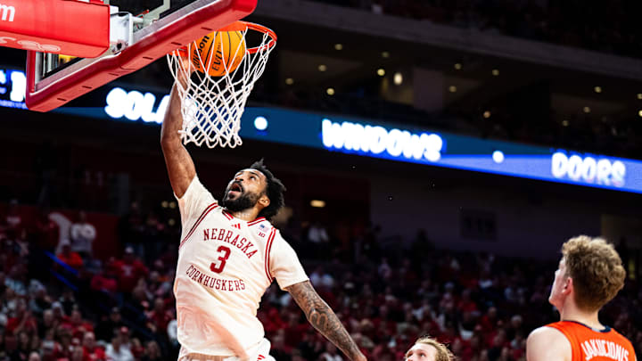 Jan 30, 2025; Lincoln, Nebraska, USA; Nebraska Cornhuskers guard Brice Williams (3) dunks the ball against Illinois Fighting Illini forward Jake Davis (15) and guard Kasparas Jakucionis (32) during the first half at Pinnacle Bank Arena. Mandatory Credit: Dylan Widger-Imagn Images