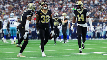 Sep 15, 2024; Arlington, Texas, USA; New Orleans Saints safety Tyrann Mathieu (32) celebrates with New Orleans Saints cornerback Alontae Taylor (1) and New Orleans Saints cornerback Kool-Aid McInstry(14) after making an interception during the second half against the Dallas Cowboys at AT&T Stadium. Mandatory Credit: Kevin Jairaj-Imagn Images