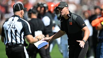 Sep 7, 2025; Cleveland, Ohio, USA; Cincinnati Bengals head coach Zac Taylor talks to down judge Derick Bowers (74) during the first half against the Cleveland Browns at Huntington Bank Field. Mandatory Credit: Ken Blaze-Imagn Images