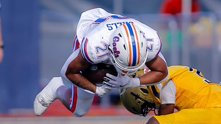 Bishop Gorman's Jonathan Coar dives for extra yardage during the Gaels' 29-21 victory over St. Thomas Aquinas, Saturday afternoon at Aquinas, in the Broward County National Football Showcase.