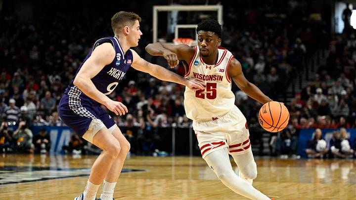 Mar 19, 2026; Portland, OR, USA; Wisconsin Badgers guard John Blackwell (25) drives against High Point Panthers guard Conrad Martinez (9) during the second half of a first round game of the men's 2026 NCAA Tournament at Moda Center. Mandatory Credit: Troy Wayrynen-Imagn Images