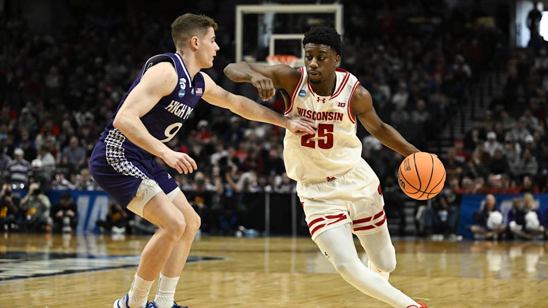 Mar 19, 2026; Portland, OR, USA; Wisconsin Badgers guard John Blackwell (25) drives against High Point Panthers guard Conrad Martinez (9) during the second half of a first round game of the men's 2026 NCAA Tournament at Moda Center. 