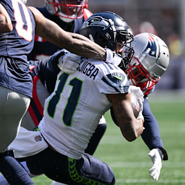 Sep 15, 2024; Foxborough, Massachusetts, USA; New England Patriots cornerback Christian Gonzalez (0) draws a penalty for hand to the face mask of Seattle Seahawks wide receiver Jaxon Smith-Njigba (11) during the first half at Gillette Stadium. Mandatory Credit: Brian Fluharty-Imagn Images