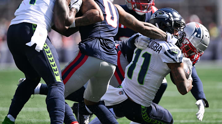 Sep 15, 2024; Foxborough, Massachusetts, USA; New England Patriots cornerback Christian Gonzalez (0) draws a penalty for hand to the face mask of Seattle Seahawks wide receiver Jaxon Smith-Njigba (11) during the first half at Gillette Stadium. Mandatory Credit: Brian Fluharty-Imagn Images