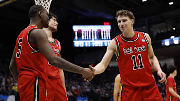 Mar 18, 2025; Dayton, OH, USA; St. Francis (Pa) Red Flash guard Daemar Kelly (5) celebrates a play with guard Riley Parker (11) in the second half against the Alabama State Hornets  at UD Arena. Mandatory Credit: Rick Osentoski-Imagn Images