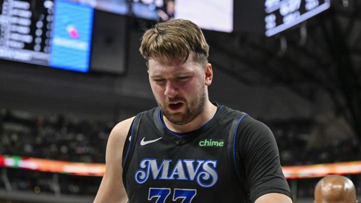 Feb 3, 2024; Dallas, Texas, USA; Dallas Mavericks guard Luka Doncic (77) leaves the game after he appears to suffer a leg injury as he battles for the loose ball with Milwaukee Bucks forward Giannis Antetokounmpo (34) during the first quarter at the American Airlines Center. Mandatory Credit: Jerome Miron-USA TODAY Sports