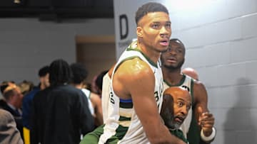Dec 13, 2023; Milwaukee, Wisconsin, USA;  Milwaukee Bucks forward Giannis Antetokounmpo (34) is restrained by a coach outside the Indiana Pacers locker room after the game at Fiserv Forum. Mandatory Credit: Benny Sieu-Imagn Images