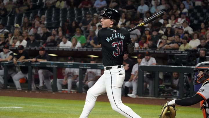Jun 3, 2024; Phoenix, Arizona, USA; Arizona Diamondbacks outfielder Jake McCarthy (31) hits a double against the San Francisco Giants in the ninth inning at Chase Field. Mandatory Credit: Rick Scuteri-USA TODAY Sports