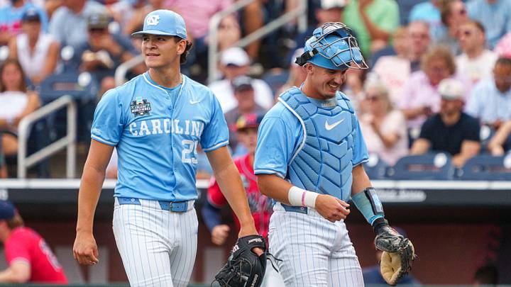 Jun 12, 2026; Omaha, NE, USA; North Carolina Tar Heels starting pitcher Jason DeCaro (29) and catcher Colin Hynek (23) walk off the field during the first inning against the Mississippi Rebels at Charles Schwab Field. Mandatory Credit: Dylan Widger-Imagn Images
