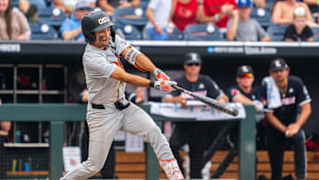 Jun 17, 2025; Omaha, Neb, USA; Oregon State Beavers second baseman AJ Singer (7) hits a single against the Louisville Cardinals during the ninth inning at Charles Schwab Field. Mandatory Credit: Dylan Widger-Imagn Images