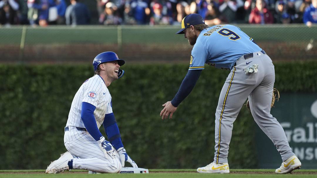 Chicago Cubs second baseman Nico Hoerner and Milwaukee Brewers first baseman Jake Bauers.