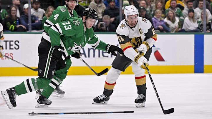 Jan 24, 2025; Dallas, Texas, USA; Dallas Stars defenseman Esa Lindell (23) and Vegas Golden Knights right wing Mark Stone (61) in action during the game between the Dallas Stars and the Vegas Golden Knights at the American Airlines Center. Mandatory Credit: Jerome Miron-Imagn Images