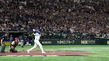Mar 15, 2025; Bunkyo, Tokyo, Japan; Los Angeles Dodgers designated hitter Shohei Ohtani (17) hits a home run against the Yomiuri Giants during the third inning at Tokyo Dome. Mandatory Credit: Darren Yamashita-Imagn Images