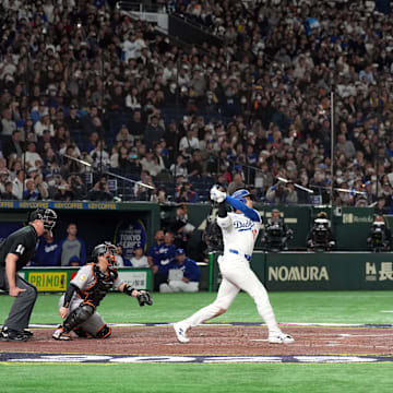 Mar 15, 2025; Bunkyo, Tokyo, Japan; Los Angeles Dodgers designated hitter Shohei Ohtani (17) hits a home run against the Yomiuri Giants during the third inning at Tokyo Dome. Mandatory Credit: Darren Yamashita-Imagn Images
