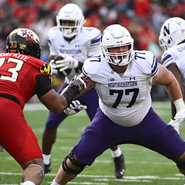 Oct 22, 2022; College Park, Maryland, USA; Northwestern Wildcats offensive lineman Peter Skoronski (77) prepares to block against the Maryland Terrapins at SECU Stadium. Mandatory Credit: Brad Mills-Imagn Images