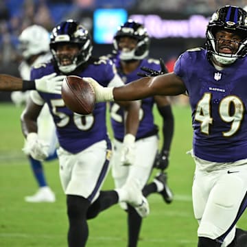 Aug 7, 2025; Baltimore, Maryland, USA; Baltimore Ravens linebacker Jay Higgins IV (49) celebrates after an interception against the Indianapolis Colts during the fourth quarter at M&T Bank Stadium. Mandatory Credit: Rafael Suanes-Imagn Images