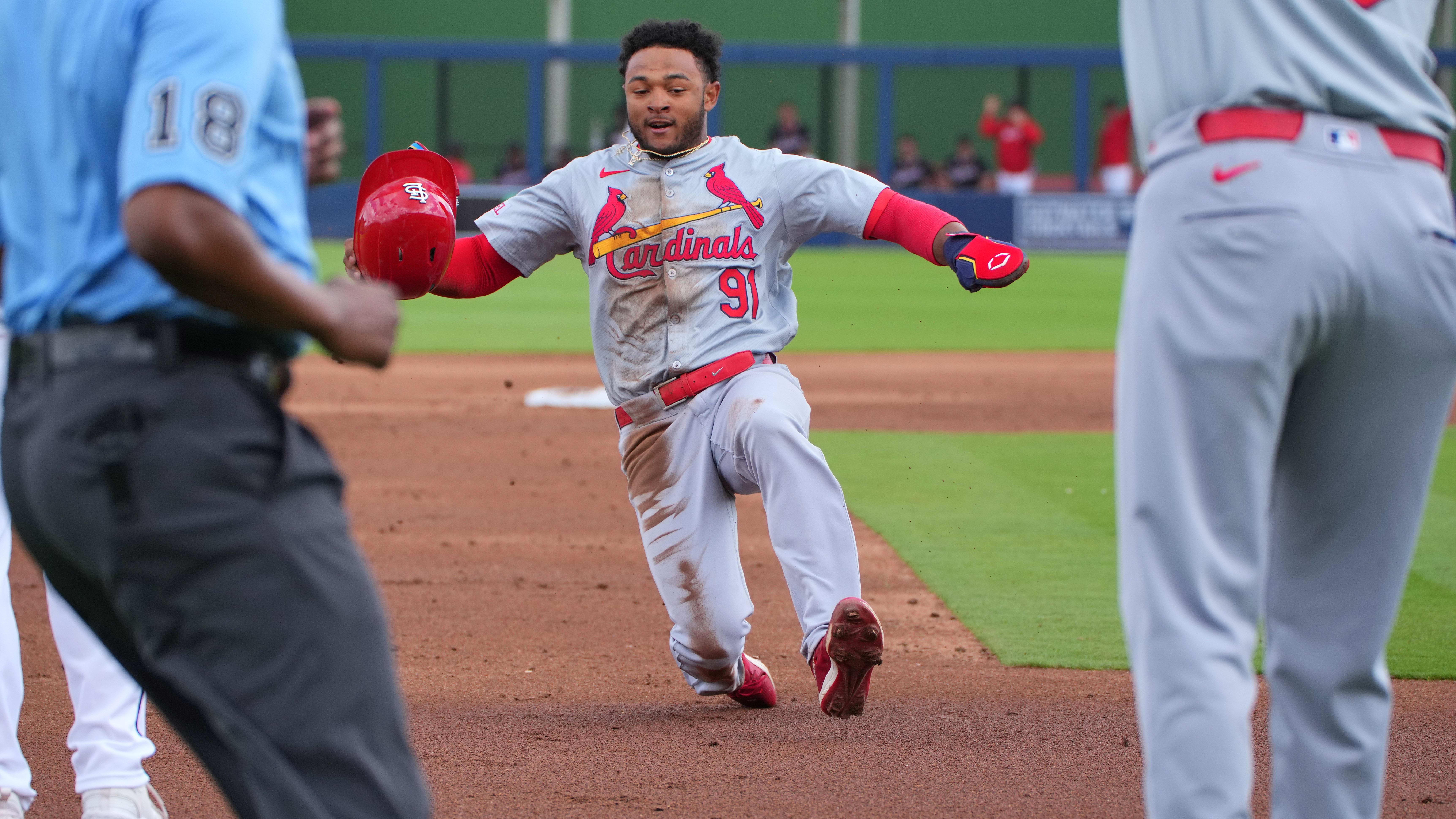 Mar 4, 2024; West Palm Beach, Florida, USA;  St. Louis Cardinals outfielder Victor Scott II slides into third base.