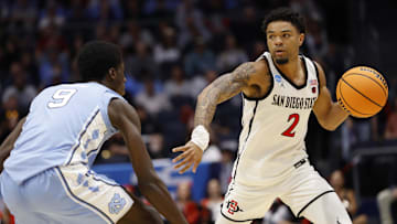 Mar 18, 2025; Dayton, OH, USA; San Diego State Aztecs guard Nick Boyd (2) plays the ball defended by North Carolina Tar Heels guard Drake Powell (9) in the first half at UD Arena. Mandatory Credit: Rick Osentoski-Imagn Images