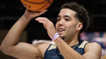 Drew Carter holds a basketball during his one season at UC Davis.
