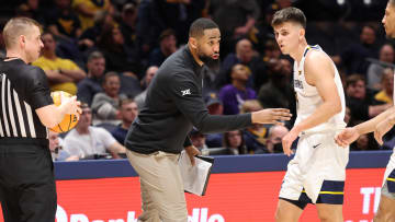 West Virginia University assistant coach Da'Sean Butler giving instructions to guards Kerr Kriisa and Noah Farrakhan. 